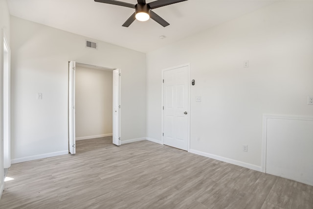 unfurnished bedroom with visible vents, light wood-style flooring, and baseboards