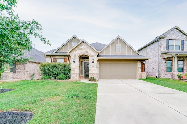 view of front of home featuring brick siding, an attached garage, a front yard, stone siding, and driveway