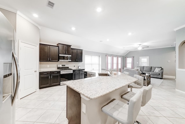 kitchen featuring appliances with stainless steel finishes, visible vents, a sink, and light tile patterned floors