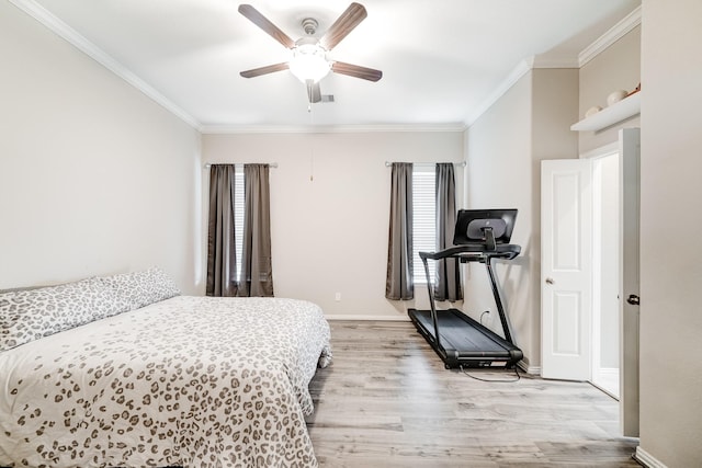 bedroom with baseboards, ceiling fan, light wood-style floors, and crown molding