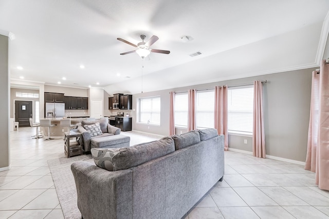 living area with baseboards, visible vents, a ceiling fan, ornamental molding, and light tile patterned flooring