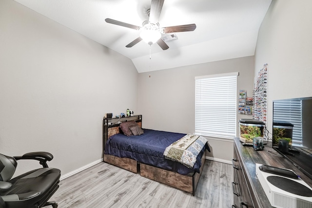 bedroom with lofted ceiling, baseboards, a ceiling fan, and light wood-style floors