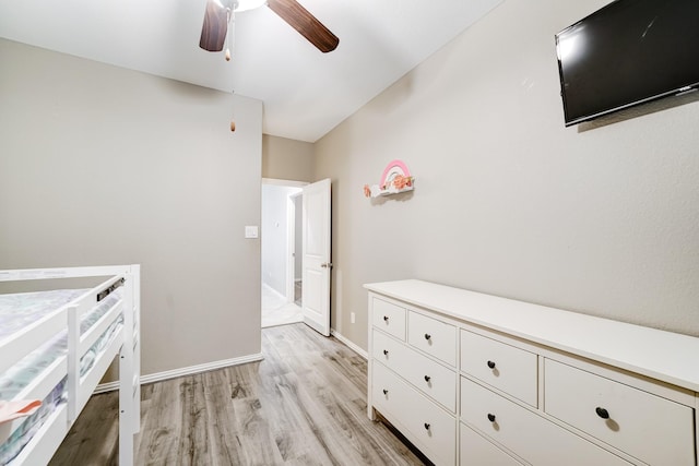 unfurnished bedroom with ceiling fan, light wood-type flooring, and baseboards