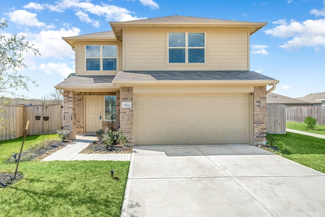 view of front of house with brick siding, fence, and an attached garage