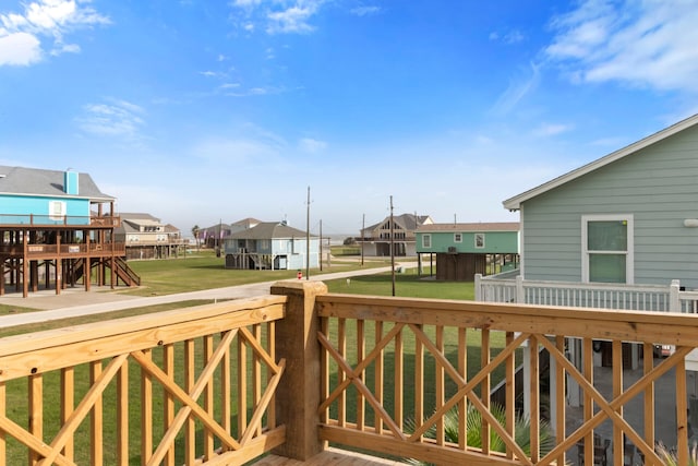 deck with a lawn and a residential view