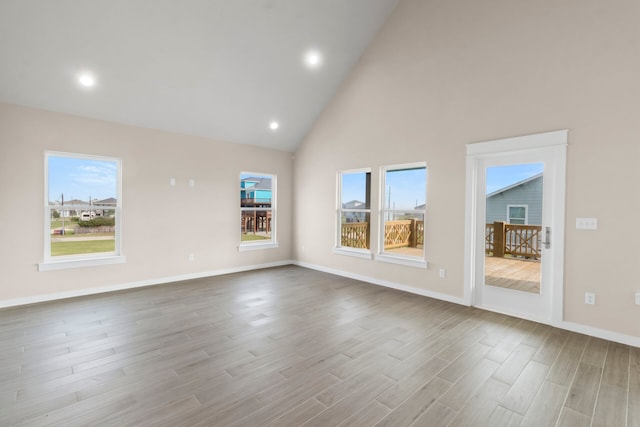 interior space featuring high vaulted ceiling, recessed lighting, baseboards, and wood finished floors