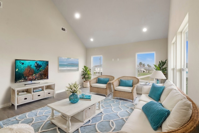 living room with high vaulted ceiling, recessed lighting, wood finished floors, visible vents, and baseboards