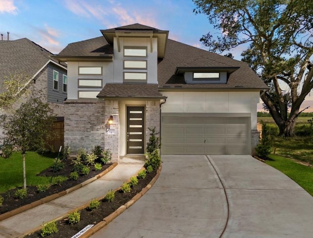 view of front of property with a garage, brick siding, concrete driveway, roof with shingles, and stucco siding