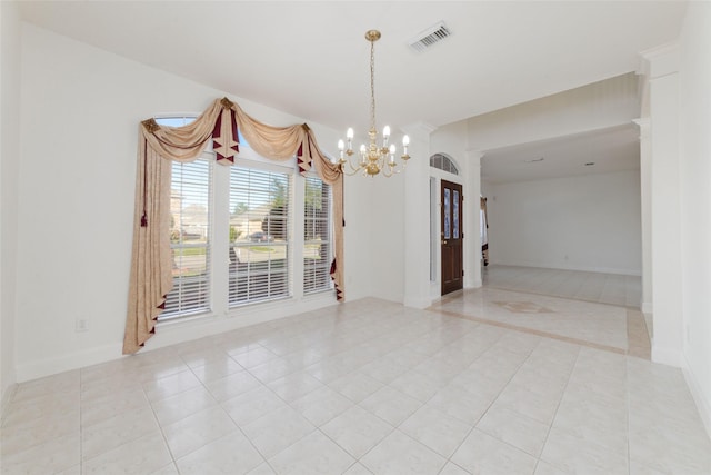 spare room featuring a chandelier, visible vents, baseboards, and light tile patterned floors