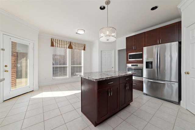 kitchen featuring decorative light fixtures, a center island, stainless steel appliances, crown molding, and light tile patterned flooring