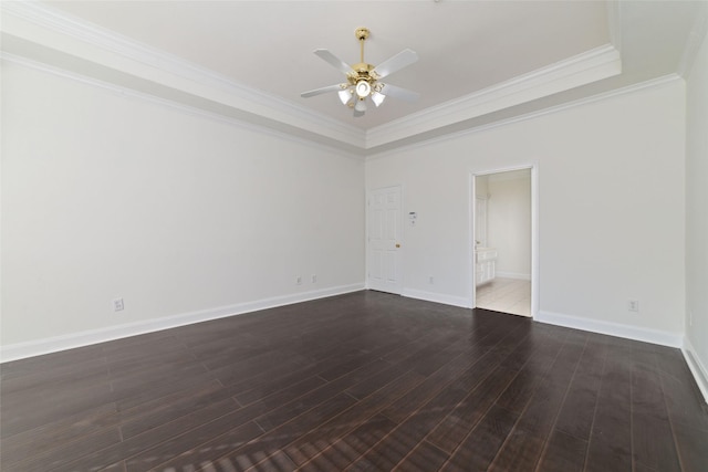 unfurnished room with ceiling fan, baseboards, dark wood-style floors, a raised ceiling, and crown molding