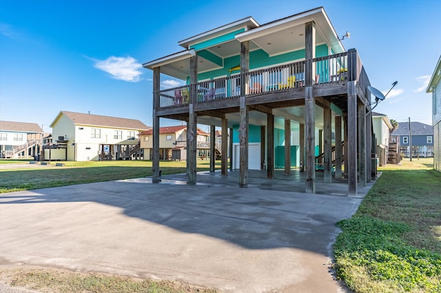 exterior space featuring a carport, a residential view, and a lawn