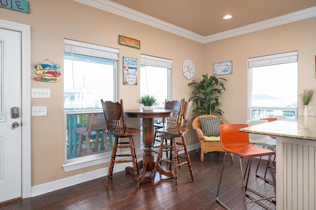 dining room with ornamental molding, recessed lighting, baseboards, and wood finished floors