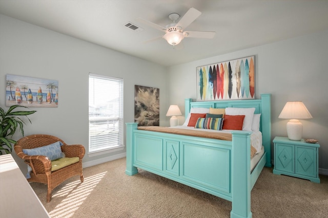 bedroom featuring light carpet, ceiling fan, visible vents, and baseboards