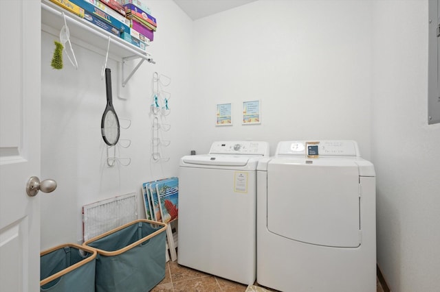 clothes washing area with washer and dryer, laundry area, and light tile patterned floors