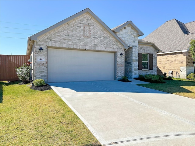 french country inspired facade featuring brick siding, an attached garage, driveway, and a front lawn