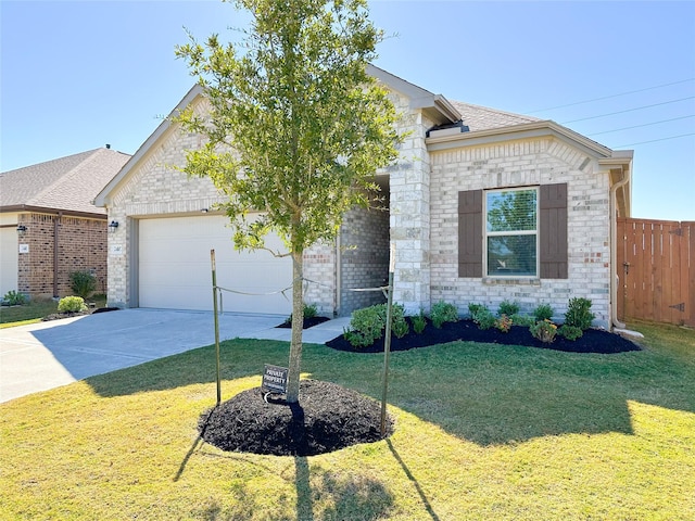 view of front of house featuring a garage, a front yard, brick siding, and driveway