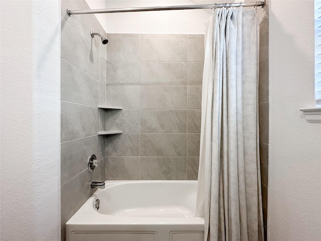 full bathroom featuring shower / tub combo and a textured wall