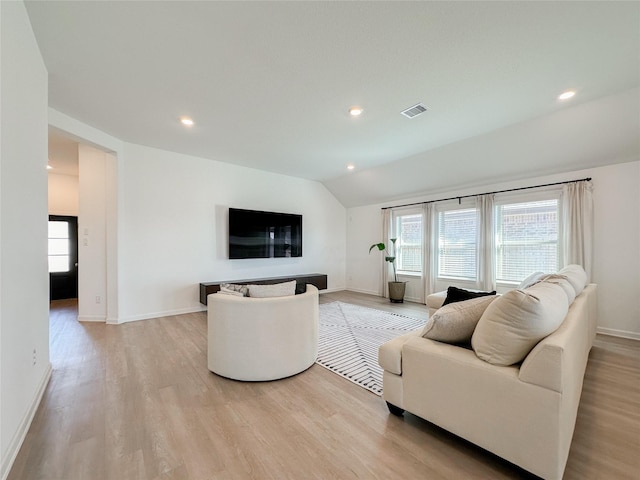 living room featuring lofted ceiling, recessed lighting, visible vents, light wood-style floors, and baseboards