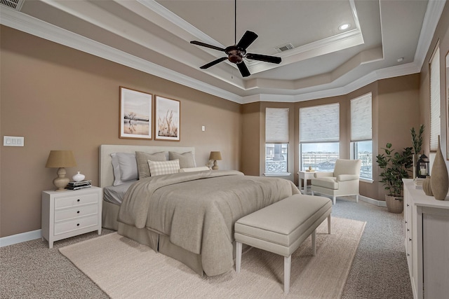 bedroom featuring ceiling fan, light colored carpet, baseboards, ornamental molding, and a raised ceiling