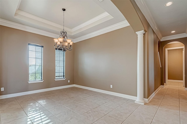 unfurnished room featuring decorative columns, arched walkways, a raised ceiling, baseboards, and ornamental molding