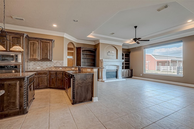 kitchen featuring a tray ceiling, appliances with stainless steel finishes, a sink, and visible vents