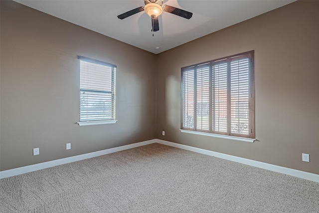 unfurnished room featuring carpet flooring, ceiling fan, and baseboards