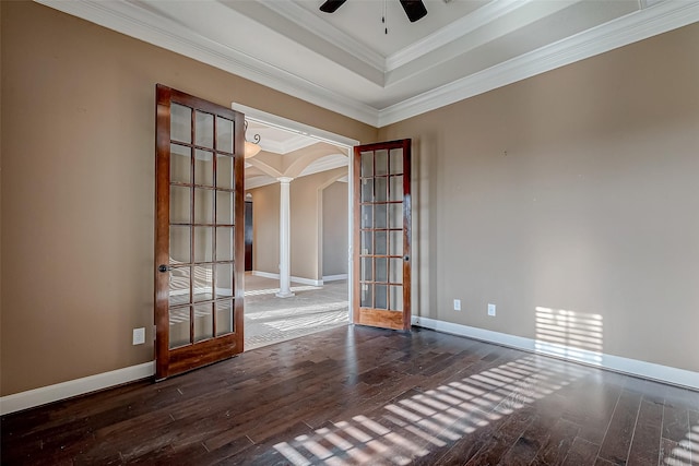 unfurnished room with arched walkways, french doors, wood-type flooring, and ornate columns