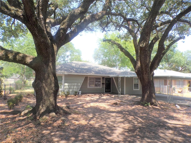 ranch-style house with fence