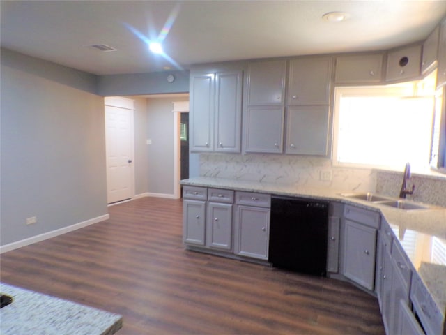 kitchen featuring black dishwasher, dark wood-style floors, a sink, and gray cabinetry