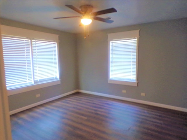 spare room with ceiling fan, baseboards, and wood finished floors