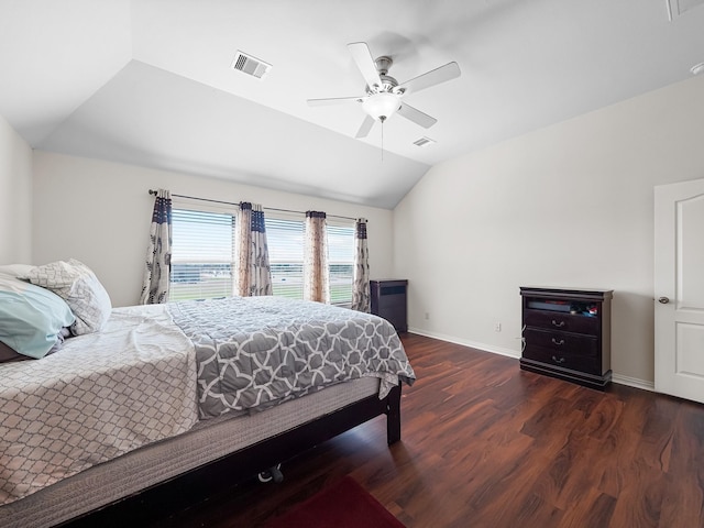 bedroom featuring ceiling fan, wood finished floors, visible vents, baseboards, and vaulted ceiling