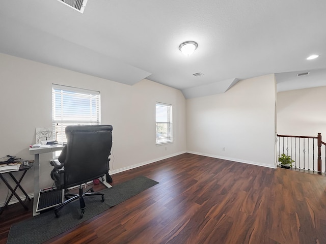 home office featuring lofted ceiling, visible vents, baseboards, and wood finished floors