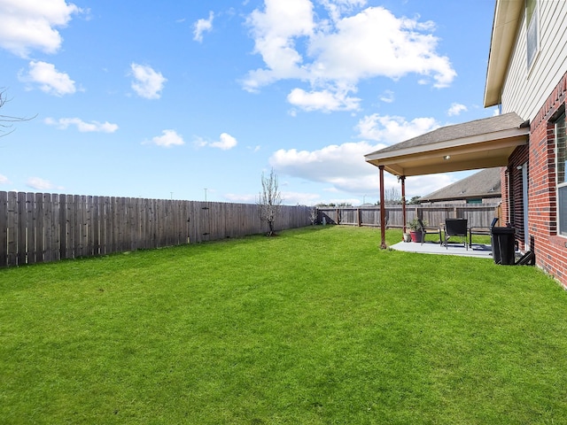 view of yard featuring a patio area and a fenced backyard