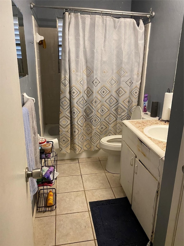 full bathroom featuring toilet, shower / bathtub combination with curtain, vanity, and tile patterned floors