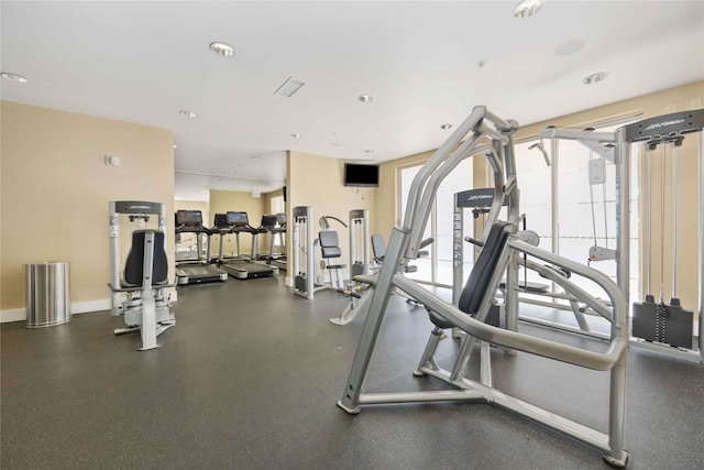 gym featuring recessed lighting and baseboards