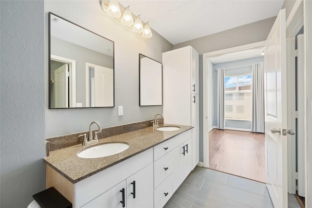 bathroom featuring double vanity, tile patterned flooring, and a sink