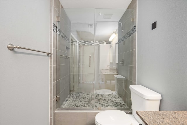 full bath with toilet, a stall shower, and vanity