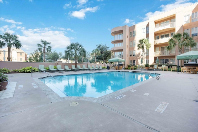 community pool with a patio area