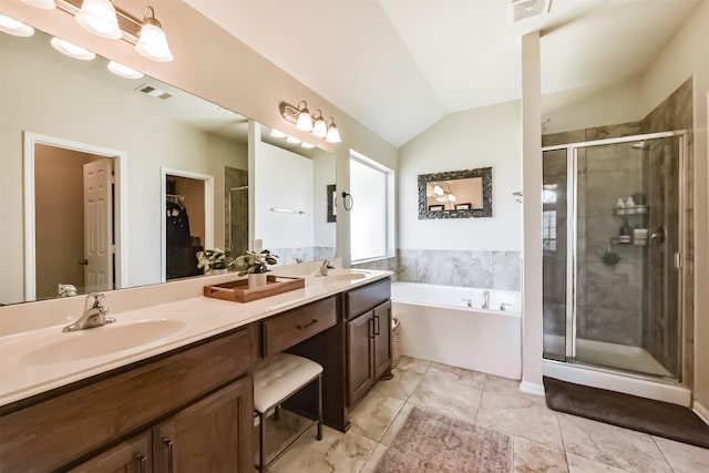 bathroom with a stall shower, a sink, and visible vents