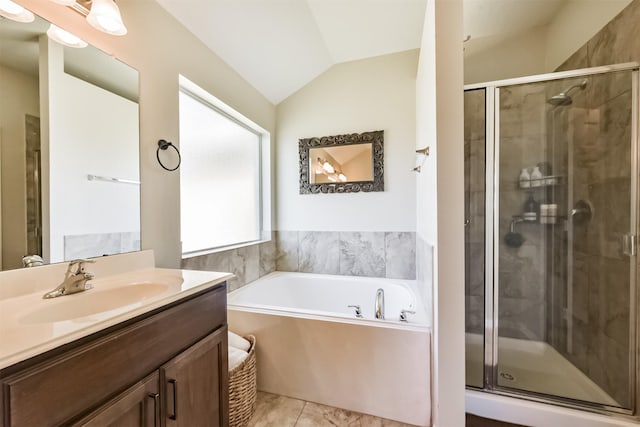 full bathroom featuring a garden tub, tile patterned flooring, vaulted ceiling, vanity, and a shower stall