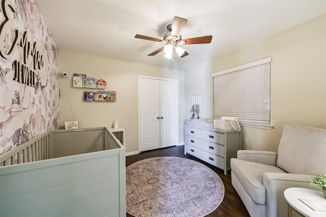 bedroom featuring dark wood-style flooring, a closet, and a ceiling fan