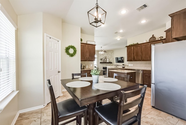 dining room featuring plenty of natural light, visible vents, baseboards, and recessed lighting