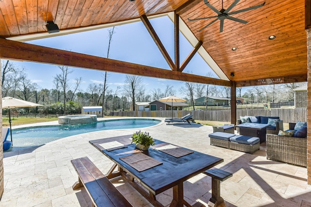 view of pool with a patio, a pool with connected hot tub, ceiling fan, a fenced backyard, and an outdoor living space