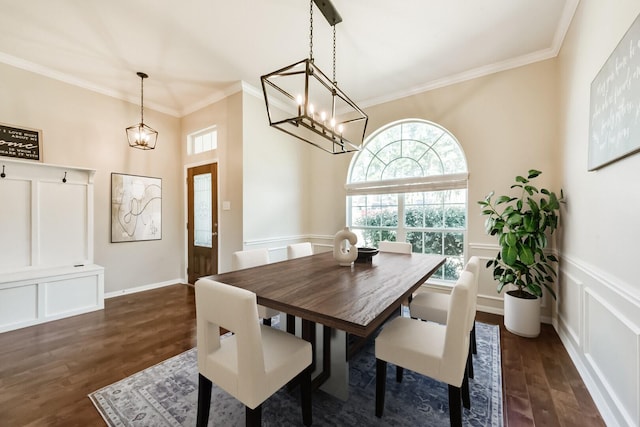 dining area featuring a chandelier, a decorative wall, ornamental molding, wainscoting, and dark wood-style floors