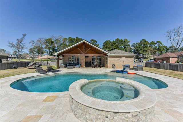 view of swimming pool featuring a patio area, a fenced backyard, a pool with connected hot tub, and an outdoor living space