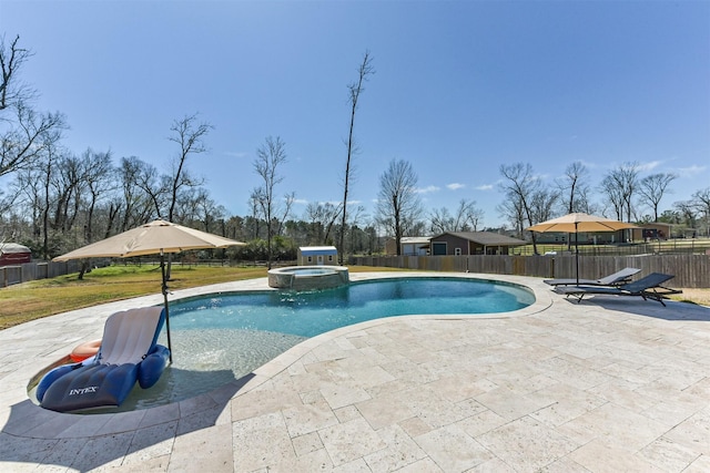 view of pool featuring a patio, fence, and a pool with connected hot tub