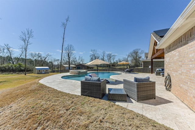 view of pool featuring a fenced backyard, an outdoor structure, a pool with connected hot tub, a yard, and a patio area