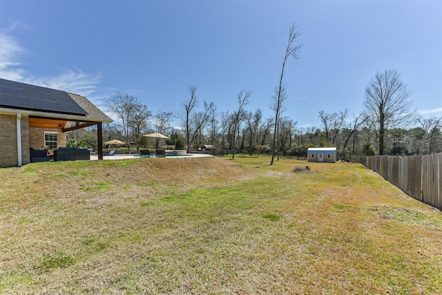 view of yard with a patio area, fence, and a fenced in pool