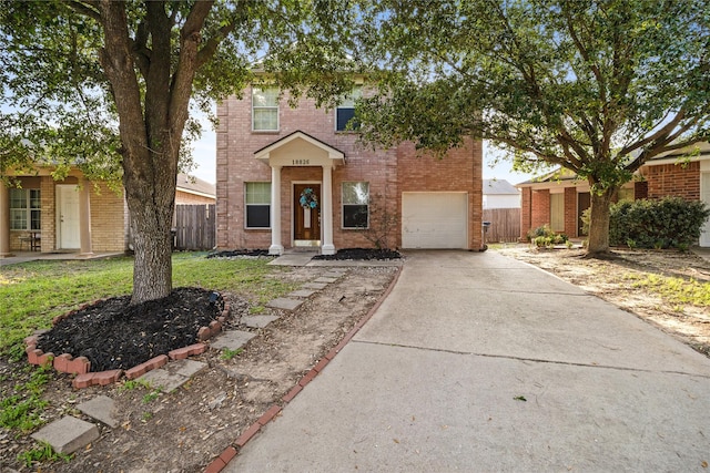 traditional home featuring concrete driveway, brick siding, fence, and an attached garage